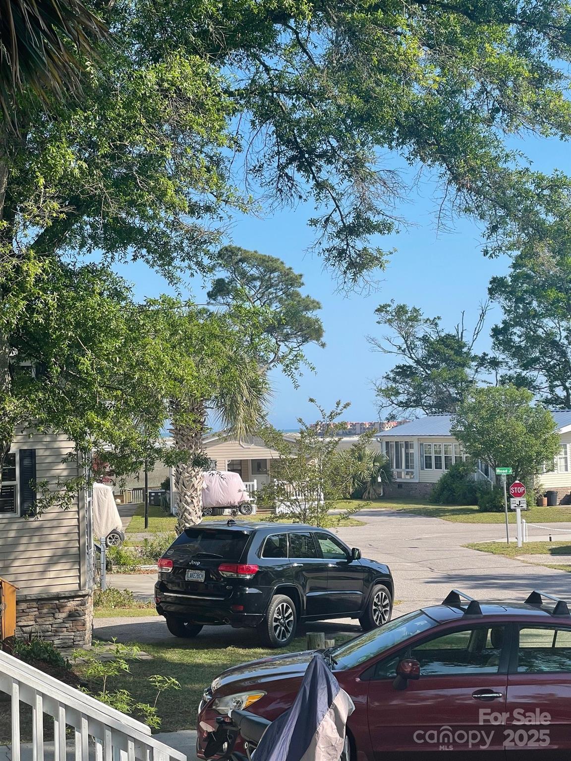 5400 Little River Neck Road, Unit 269 North Myrtle Beach, SC 29582 - Photo 17 of 22 a view of a yard in front of a house with cars parked on road
