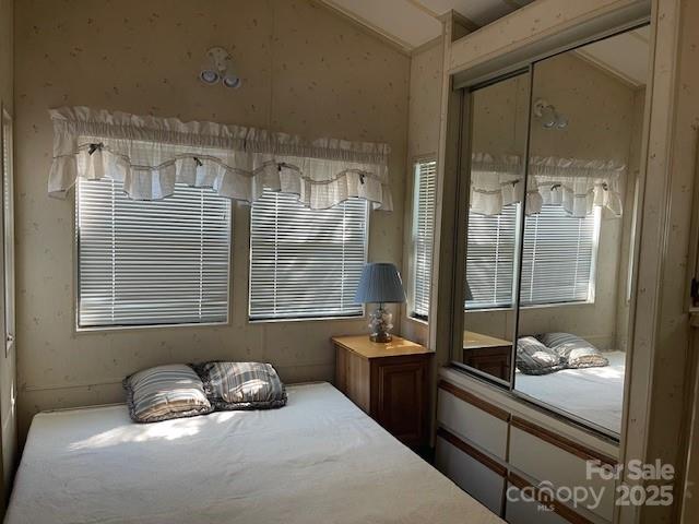 5400 Little River Neck Road, Unit 269 North Myrtle Beach, SC 29582 - Photo 10 of 22 a bedroom with a bed and glass window