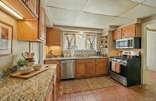a kitchen with a sink stove and microwave