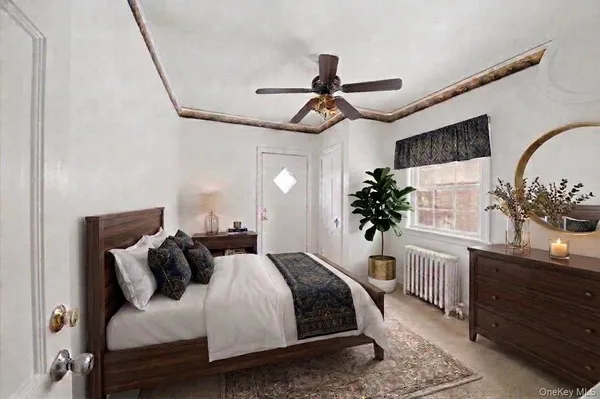 a bedroom with a bed a dresser and potted plants