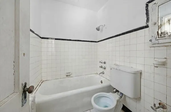 a bathroom with a sink a toilet and bathtub