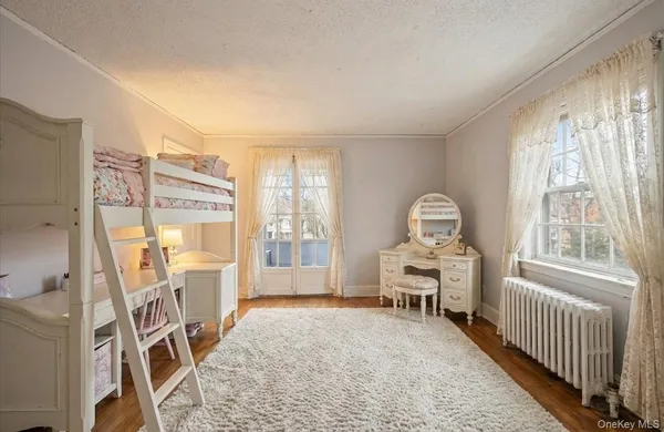 a bedroom with furniture and a window