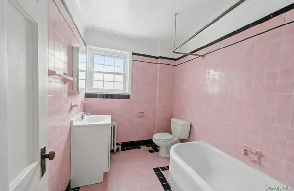 a bathroom with a sink toilet and tub