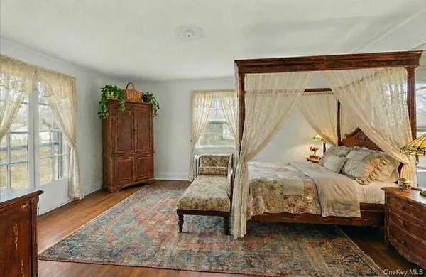 a bedroom with furniture and a window