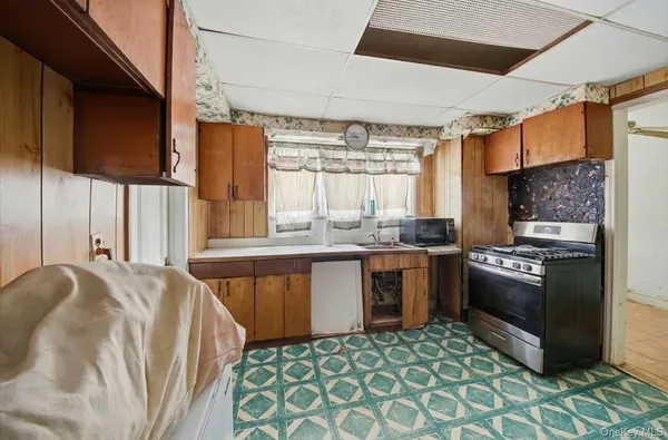 a kitchen with stainless steel appliances granite countertop a sink a stove and a refrigerator
