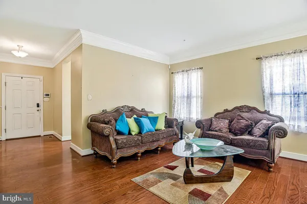 a living room with furniture dining table and a chandelier