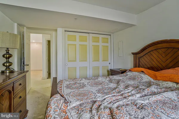 a bedroom with a bed and a dresser