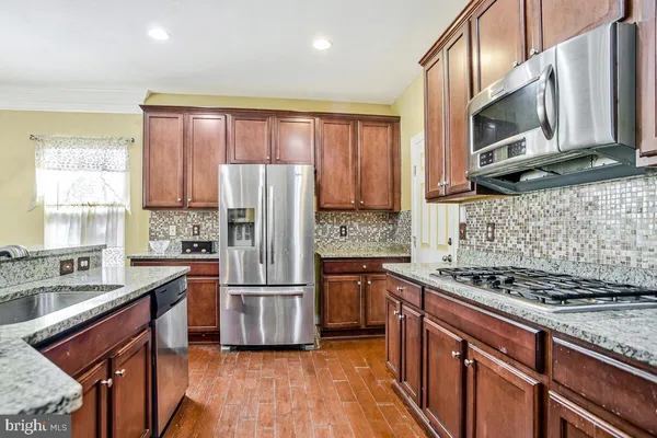a kitchen with granite countertop a sink and a counter top space