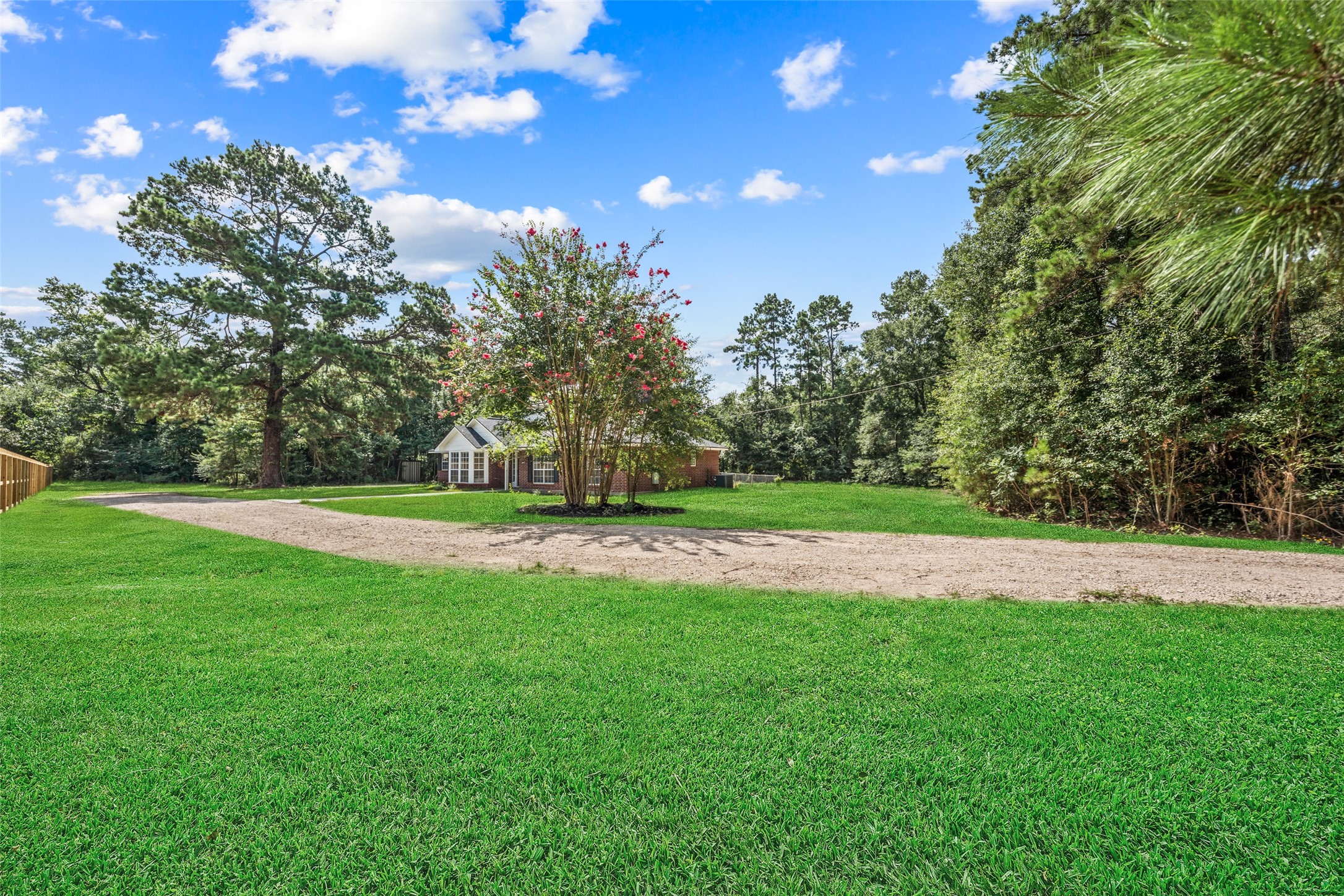 14989 Old Humble Pipeline Road Conroe, TX 77302 - Photo 3 of 33 Gravel driveway leads to the house on this 1.398 acre property. *grass has been superimposed*