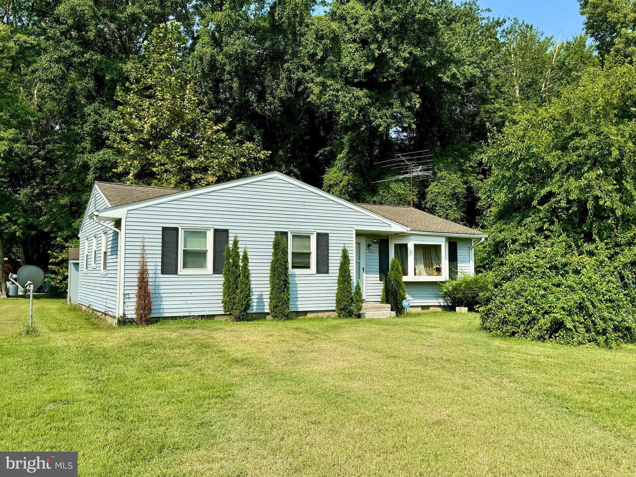 13404 Cannery Road Queen Anne, MD 21657 - Photo 2 of 14 a front view of house with yard and trees in the background