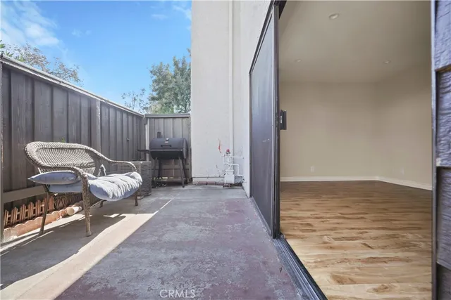 a balcony with furniture and a potted plant