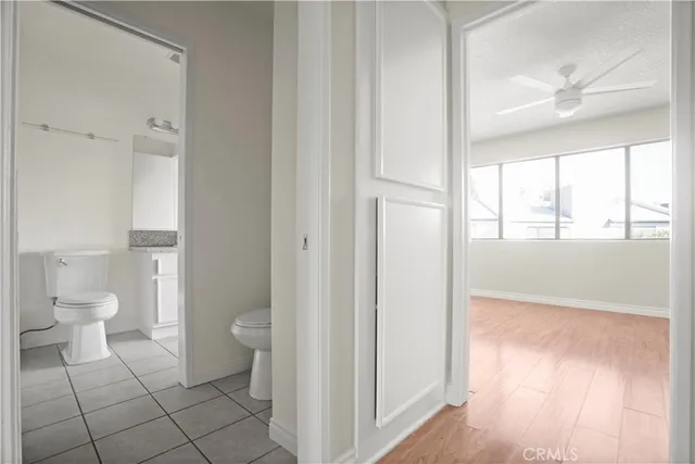 a bathroom with a granite countertop toilet and a shower
