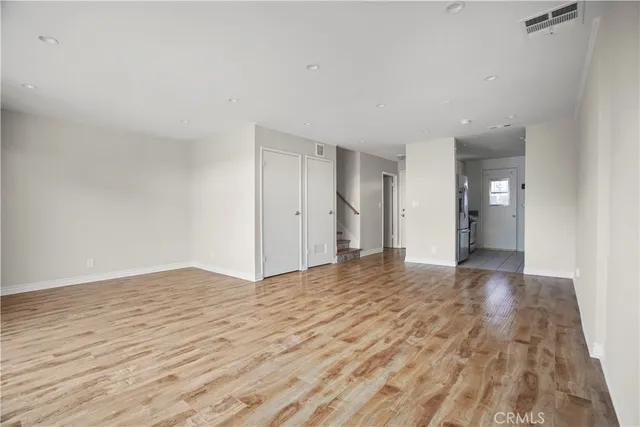 a view of an empty room and wooden floor