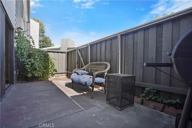 a backyard of a house with table and chairs