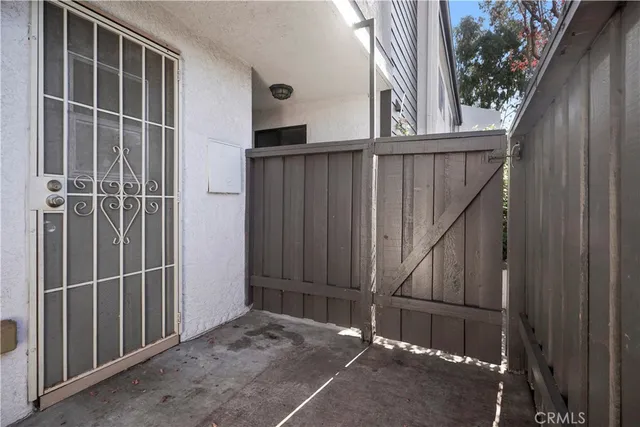 a view of a house with backyard and wooden door