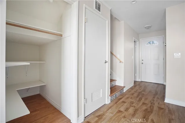 a view of hallway with wooden floor