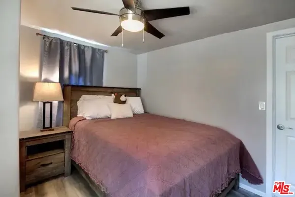 a bedroom with a bed and a lamp