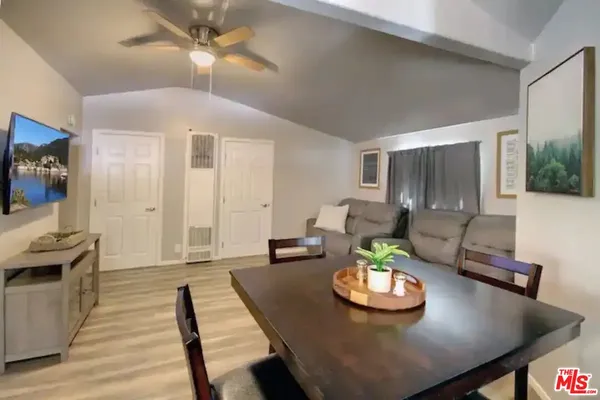 a living room with furniture and a dining table
