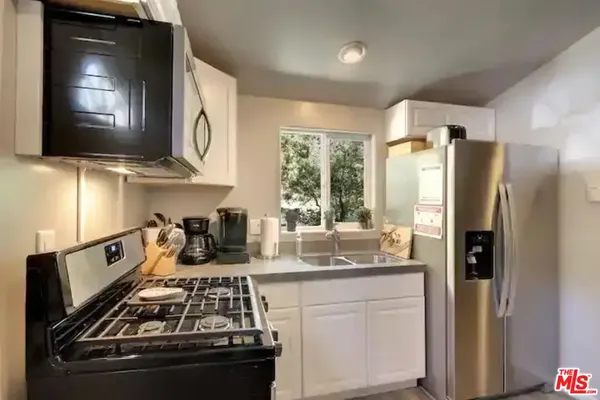 a kitchen with a stove and a refrigerator