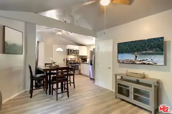 a view of a dining room with furniture wooden floor and flat screen tv