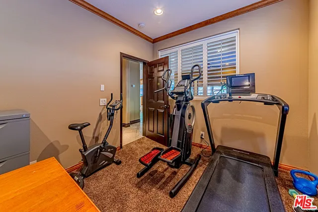 a view of staircase with railing and a chandelier