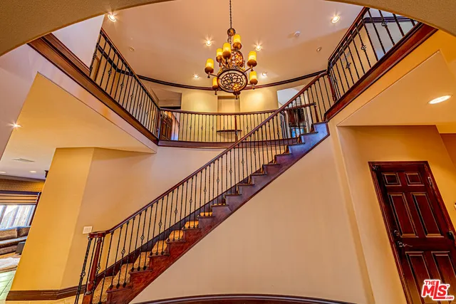 a room with pool table windows and wooden floor