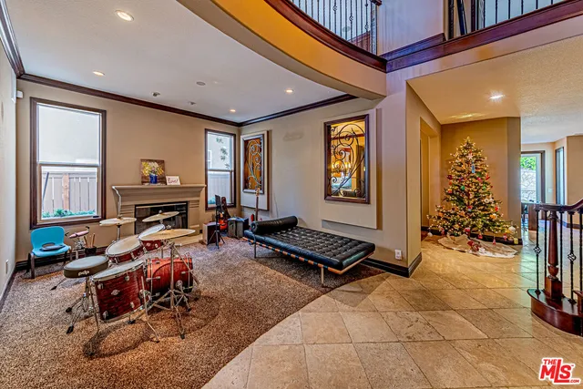 a room with furniture gym equipment and a large window