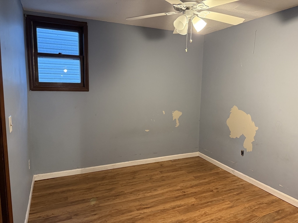 163 Warren Street, Unit 1 Fall River, MA 02721 - Photo 5 of 6 a view of a room with wooden floor and fan