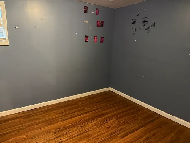 a view of small space with wooden floor and a ceiling fan