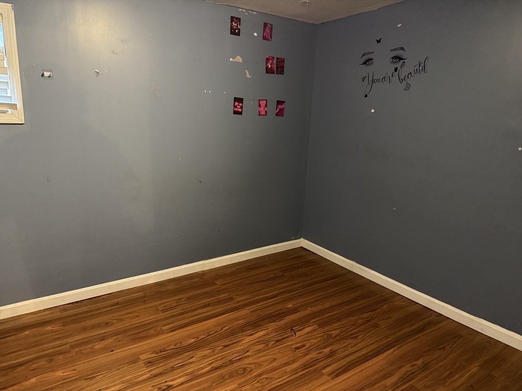 163 Warren Street, Unit 1 Fall River, MA 02721 - Photo 6 of 6 a view of small space with wooden floor and a ceiling fan