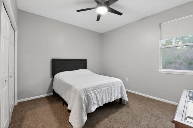 a bedroom with a bed and window