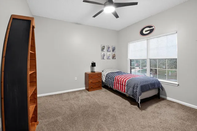 a spacious bedroom with a bed and a window