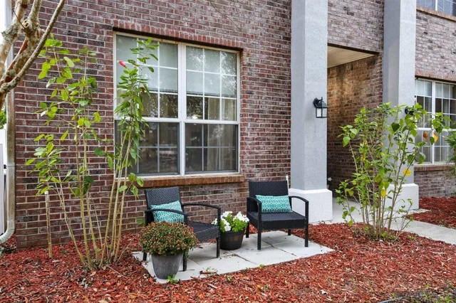 a view of a door with a chairs and table in a patio
