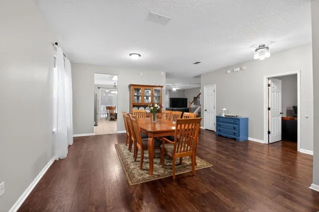a view of a dining room with furniture and wooden floor