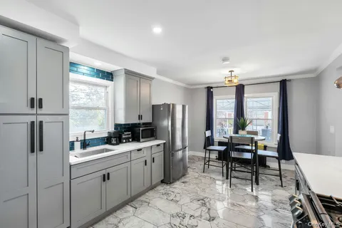 a kitchen with sink cabinets and refrigerator