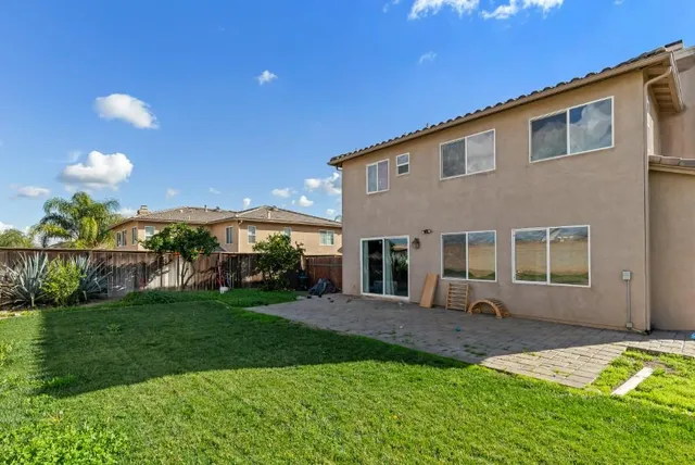 a front view of a house with a yard and porch