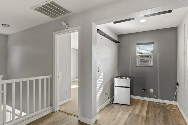 a view of a walk in closet and wooden floor