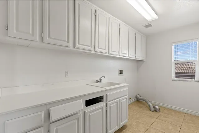 a view of a kitchen with white cabinets