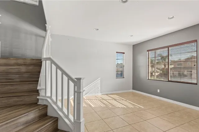 a view of a livingroom with wooden floor and stairs