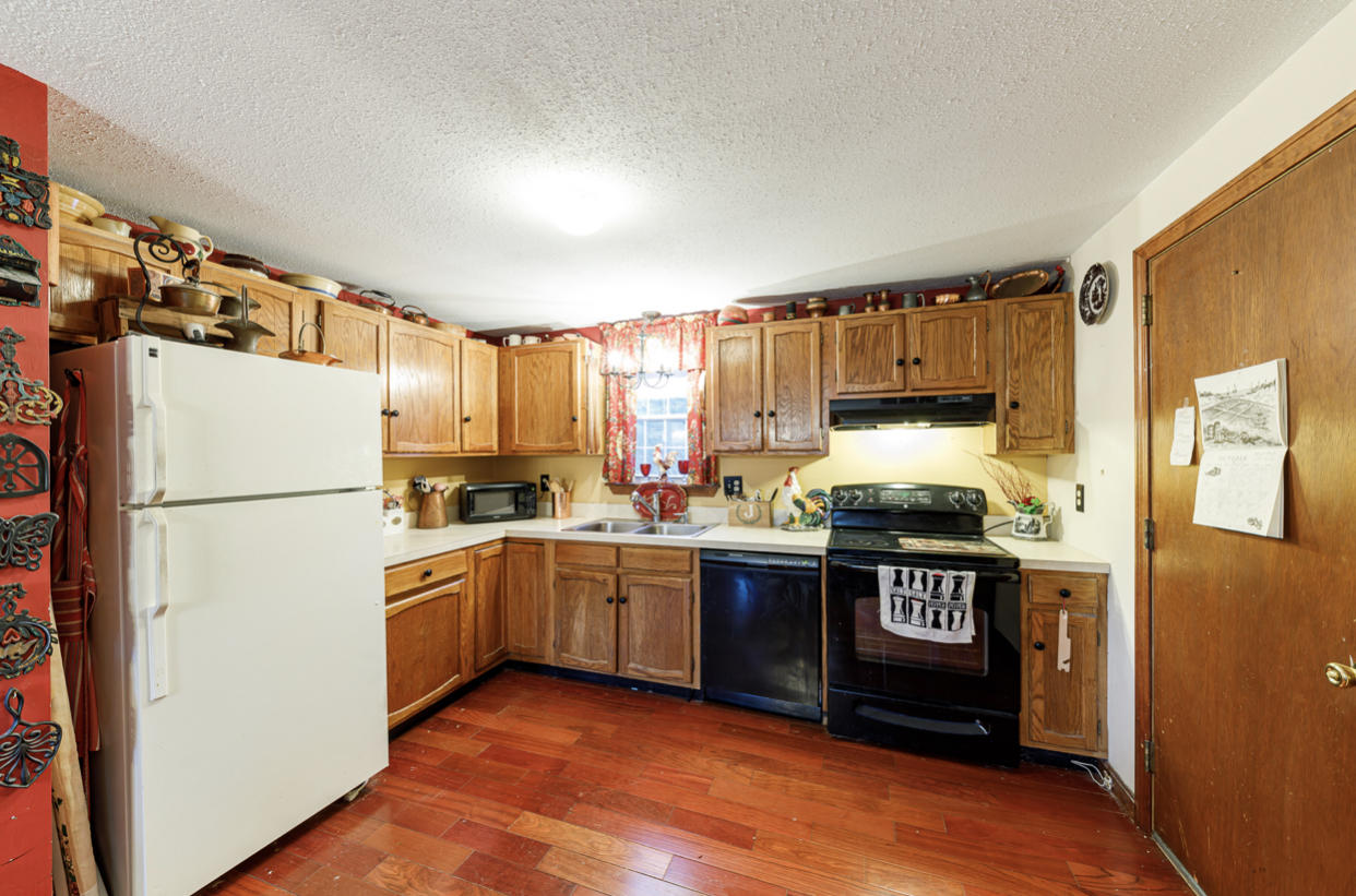 12 Ebenezer Road Osterville, MA 02655 - Photo 16 of 22 a kitchen with stainless steel appliances granite countertop a refrigerator a stove a sink and a microwave