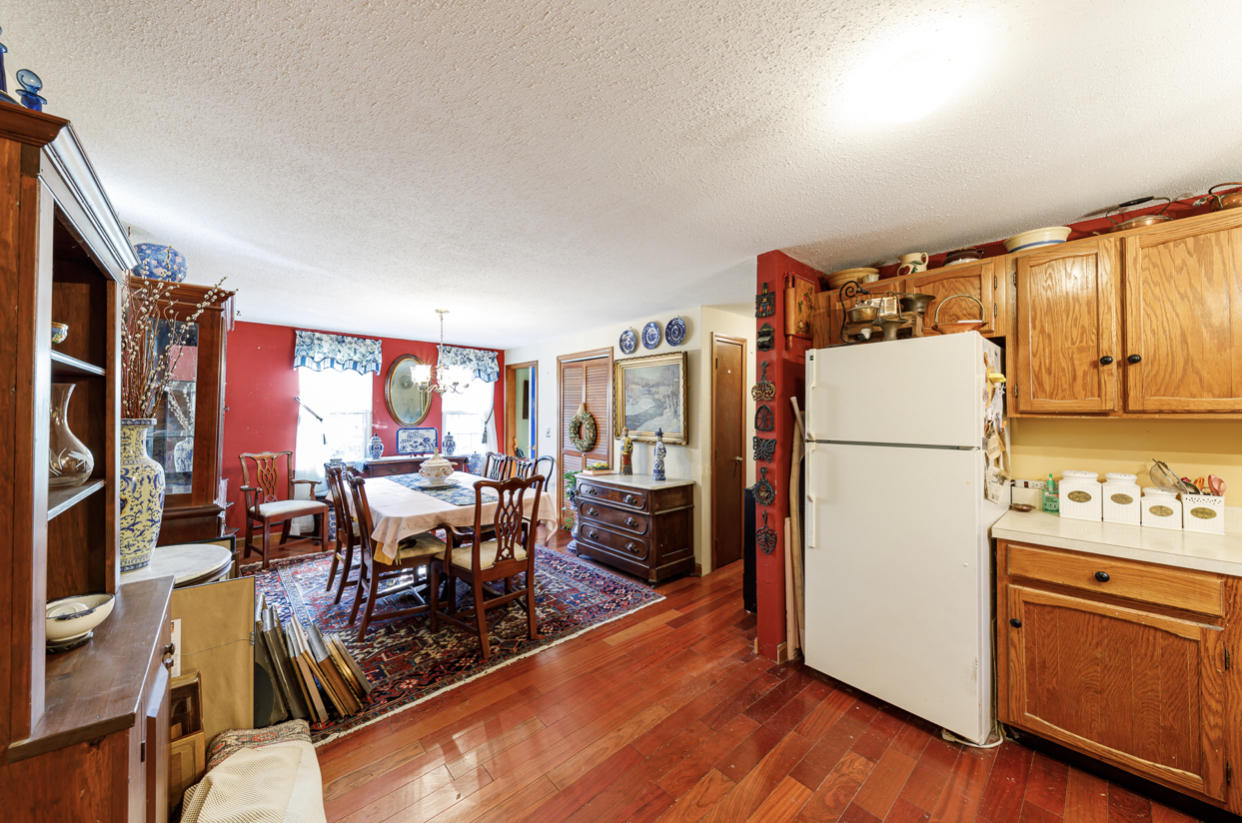 12 Ebenezer Road Osterville, MA 02655 - Photo 17 of 22 a kitchen with stainless steel appliances granite countertop a refrigerator a stove a sink dishwasher and a dining table with the wooden floor