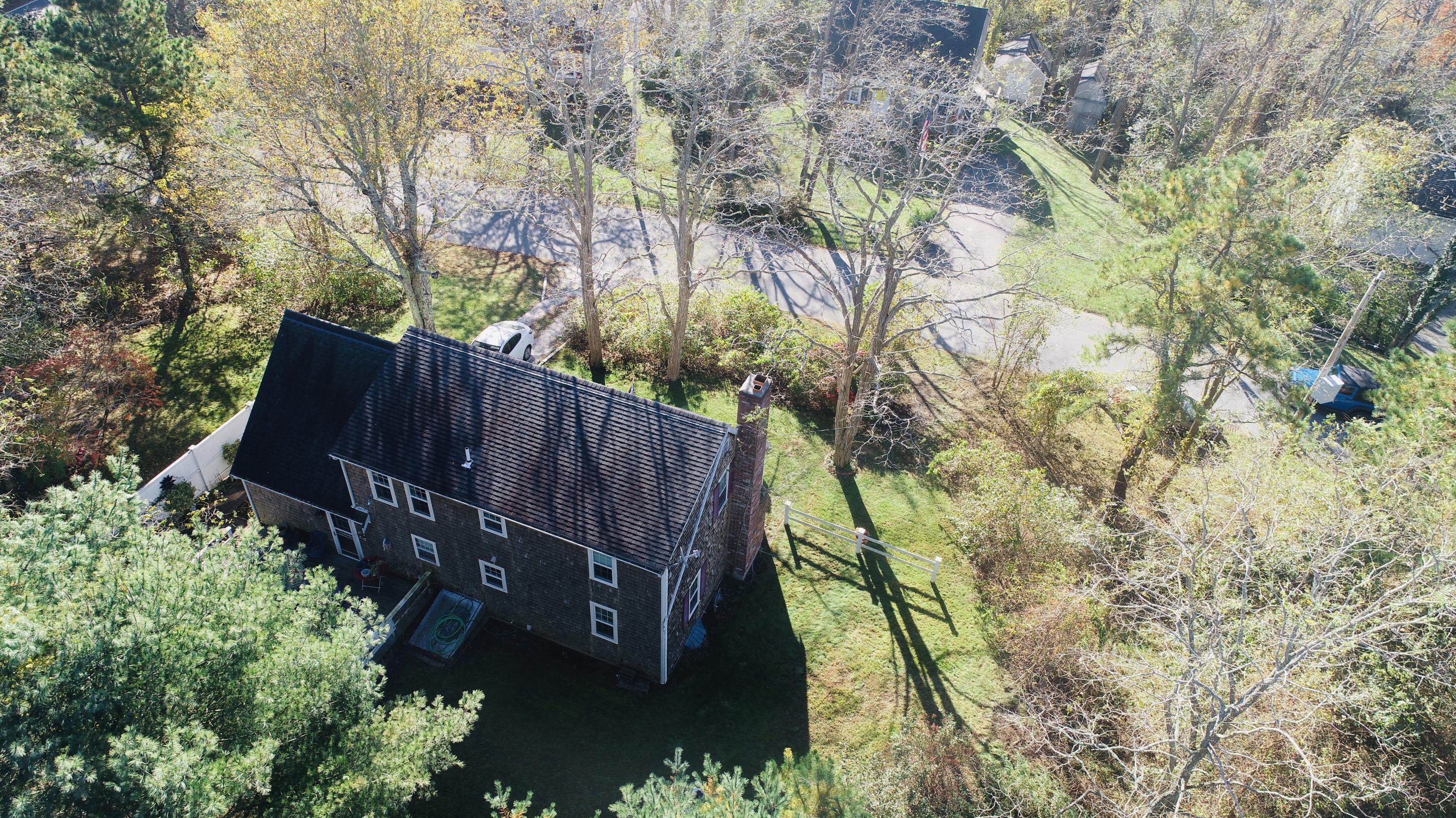 12 Ebenezer Road Osterville, MA 02655 - Photo 2 of 22 a view of a backyard with plants and large trees