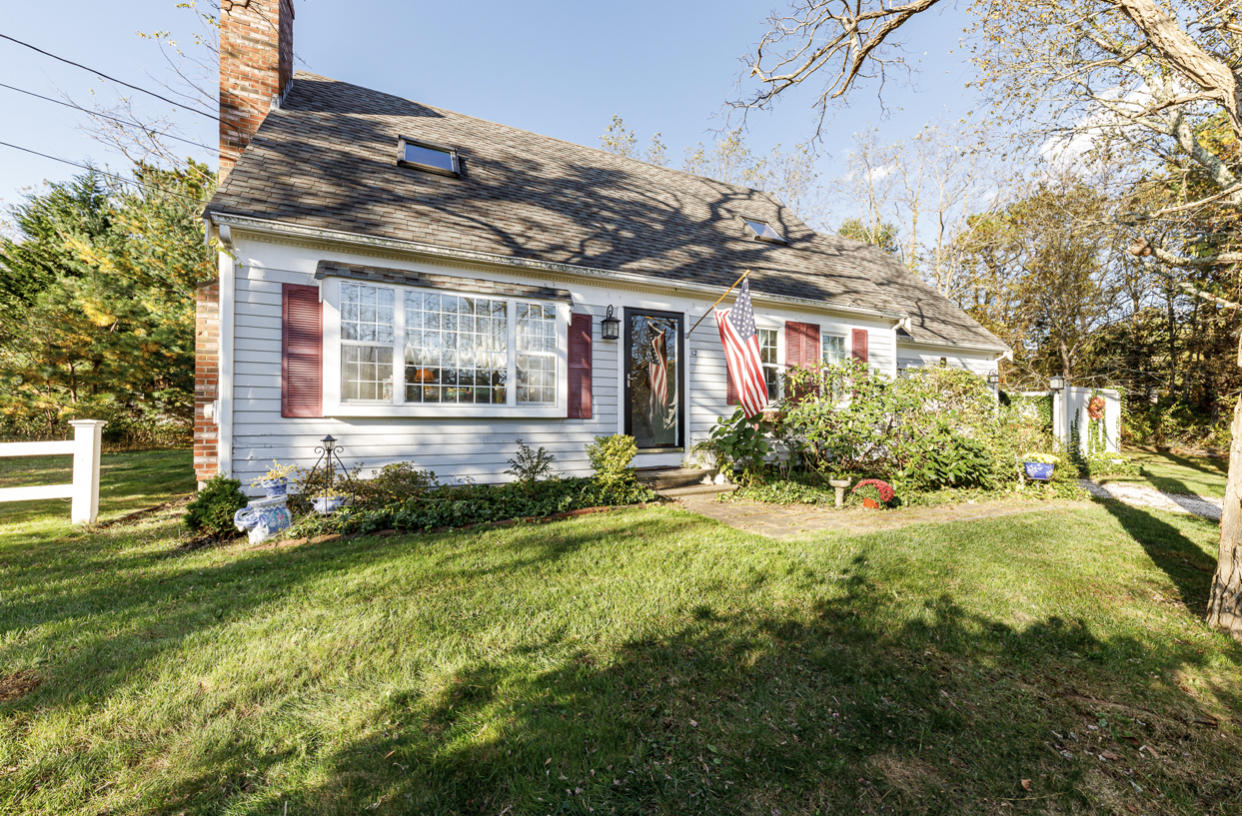 12 Ebenezer Road Osterville, MA 02655 - Photo 6 of 22 a view of a house with a small yard and plants