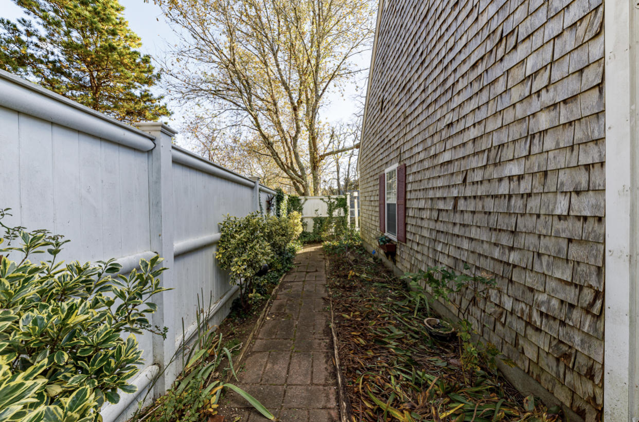 12 Ebenezer Road Osterville, MA 02655 - Photo 9 of 22 a view of a pathway with a flower garden
