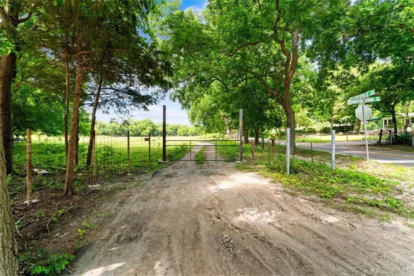 a view of a park with trees in the background