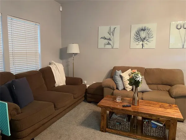 a living room with furniture a couch and wooden floor
