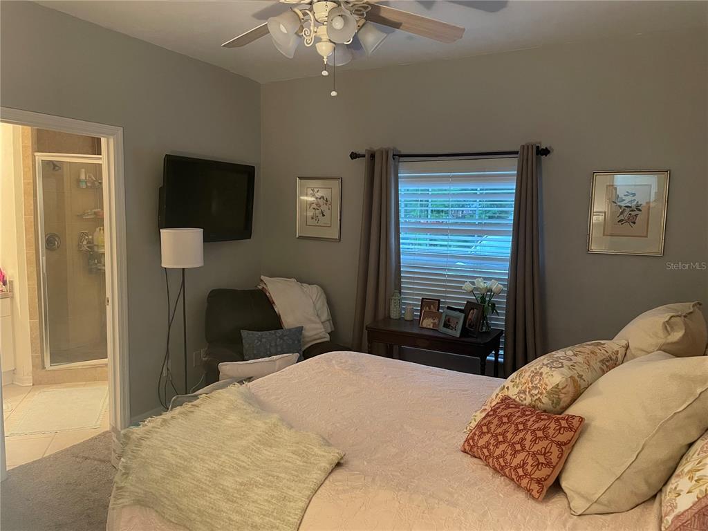 4945 Northwest 1st Place Gainesville, FL 32607 - Photo 5 of 9 a bedroom with a bed and a television