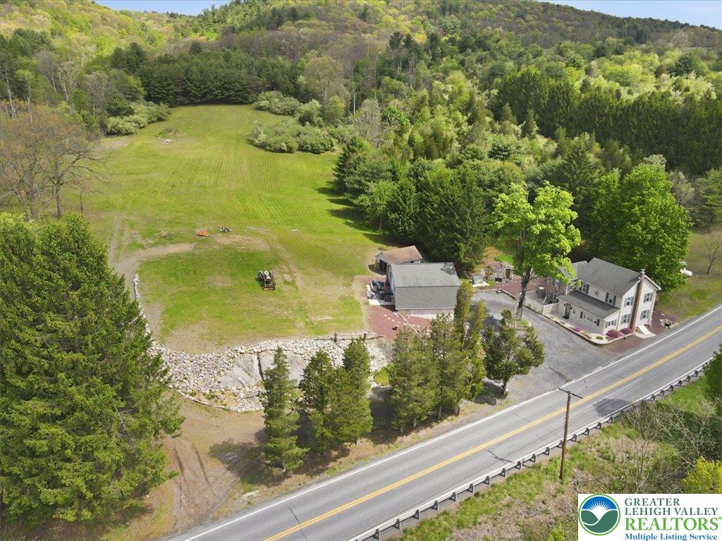 4880 Little Gap Road Kunkletown, PA 18058 - Photo 91 of 100 This elevated view captures a serene residence nestled amidst lush greenery and open spaces.