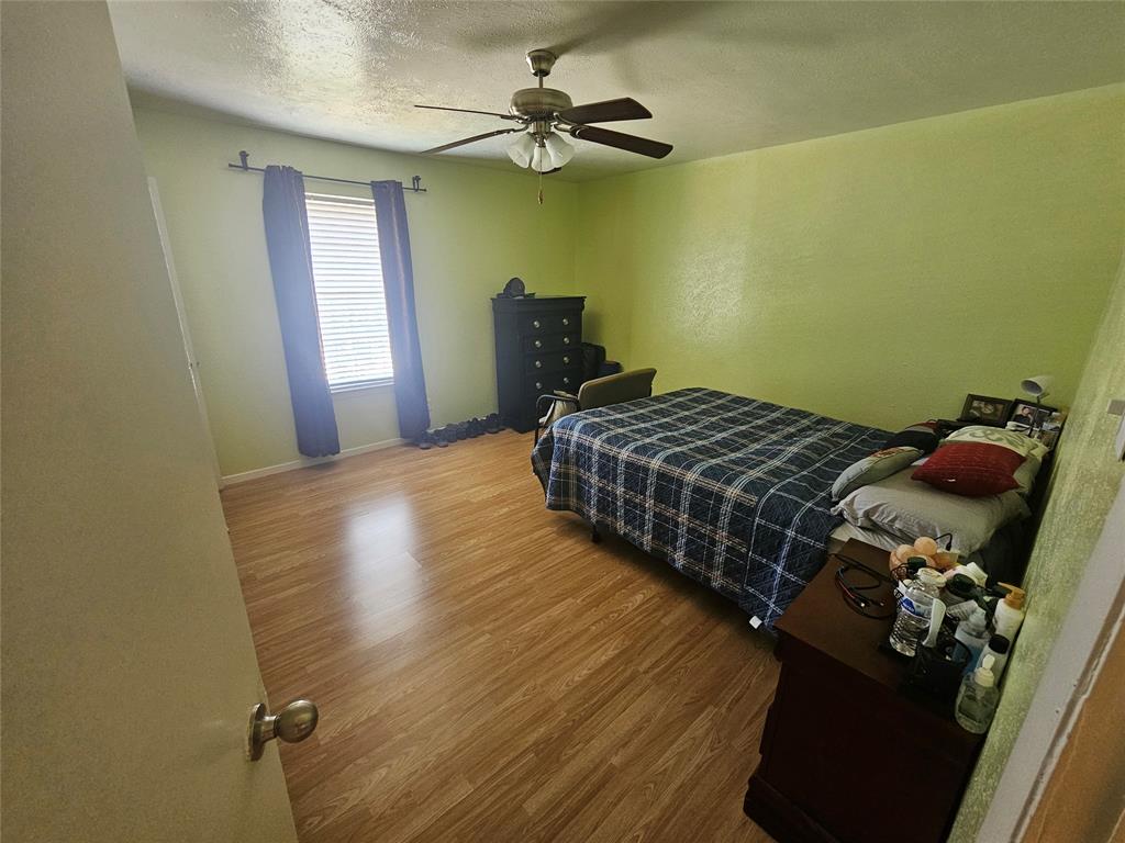 1823 East Grauwyler Road, Unit 198 Irving, TX 75061 - Photo 4 of 9 a bedroom with a bed and a chandelier