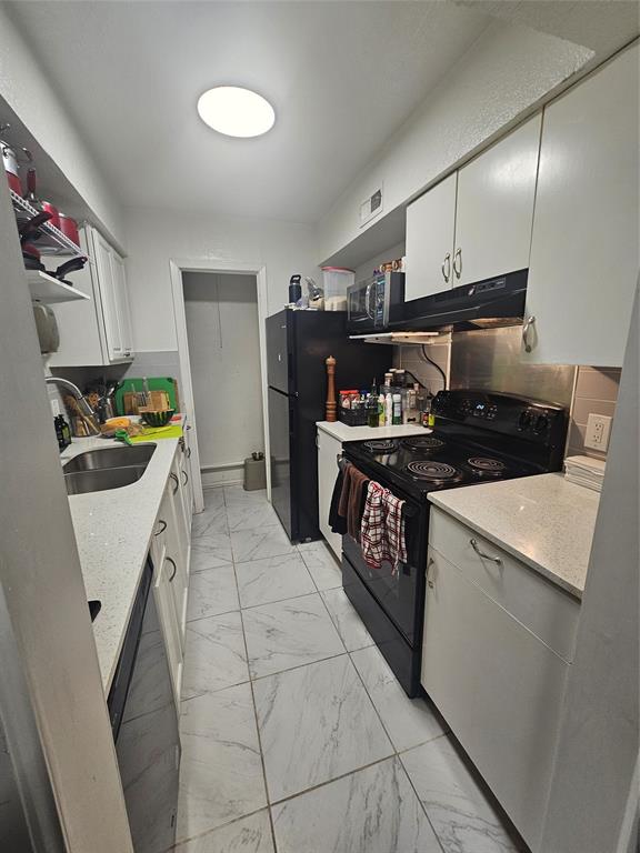 1823 East Grauwyler Road, Unit 198 Irving, TX 75061 - Photo 6 of 9 a kitchen with stainless steel appliances granite countertop a stove a sink and a refrigerator